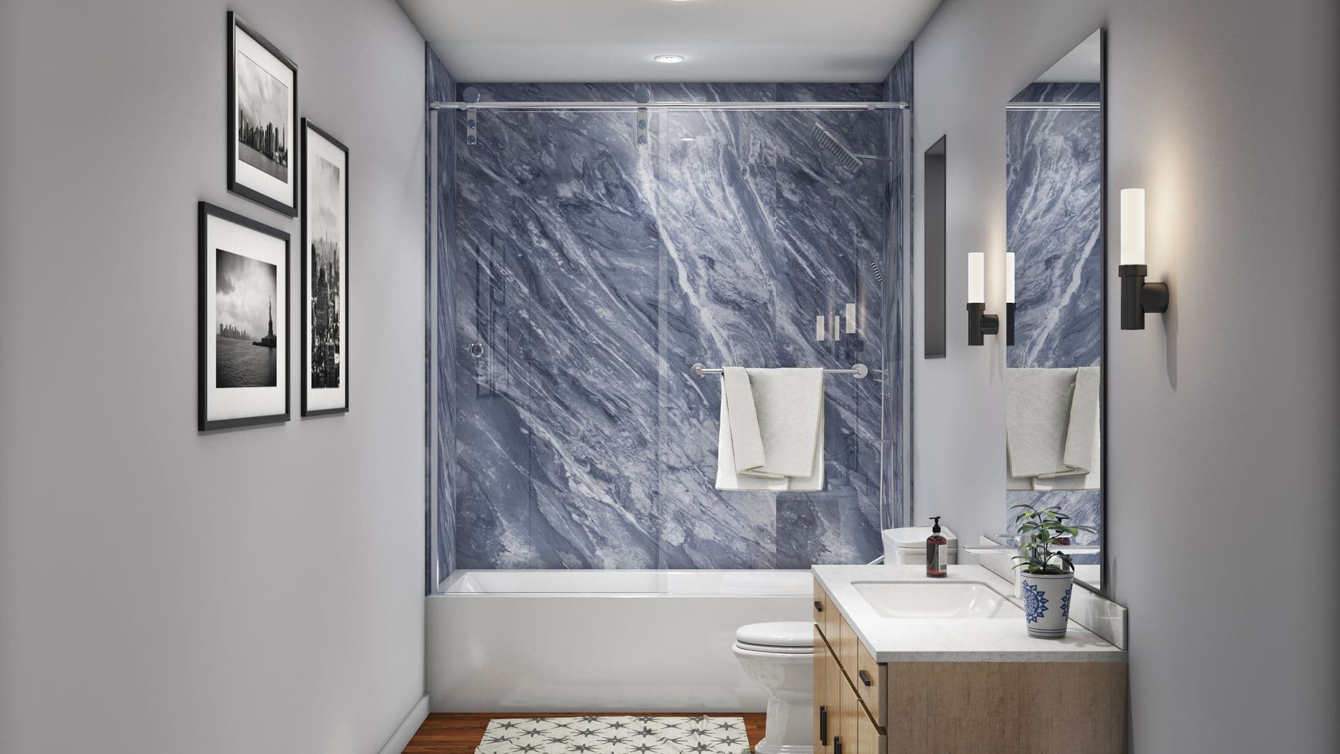 Modern bathroom with blue marble shower walls, white bathtub, and a wooden vanity. Black-and-white photos hang on a gray wall, and soft lighting adds a cozy feel.